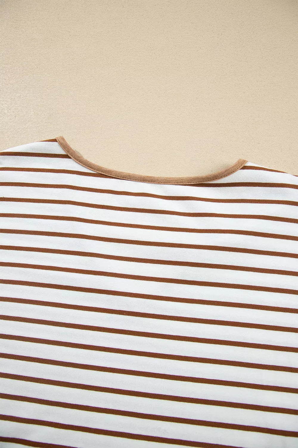 Close-up of the back neckline of the striped lounge top with camel binding