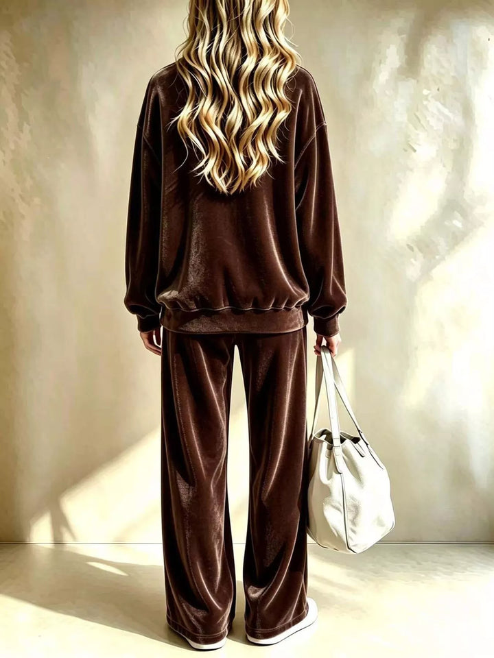 Chocolate pullover and wide leg pants set from the back with a white bag