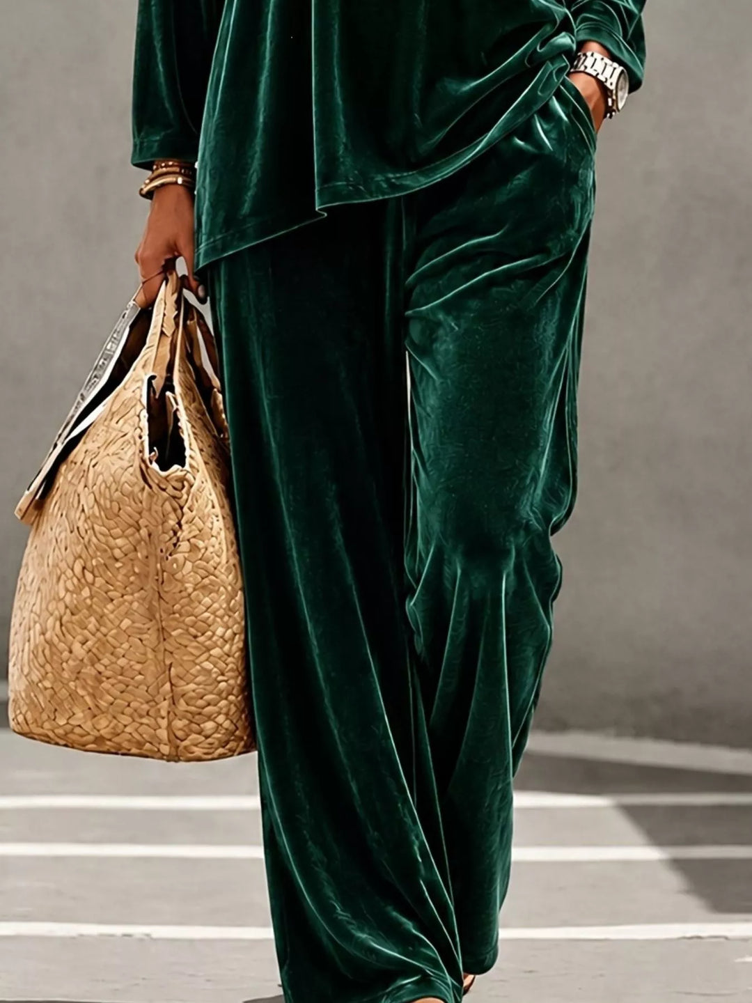 Green velvet wide leg pants and hem of the top, cropped view
