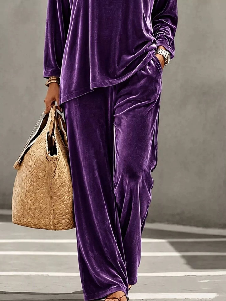 Purple velvet wide leg pants with tote bag, cropped styling shot