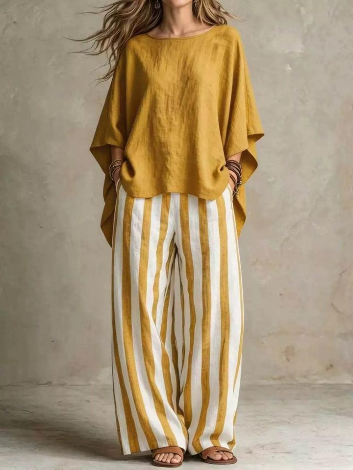 Mustard batwing top with striped wide leg pants, full length front view
