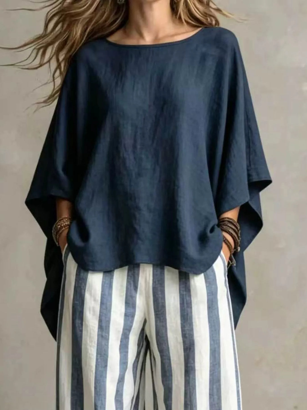 Navy batwing top with striped wide leg pants, closer front view