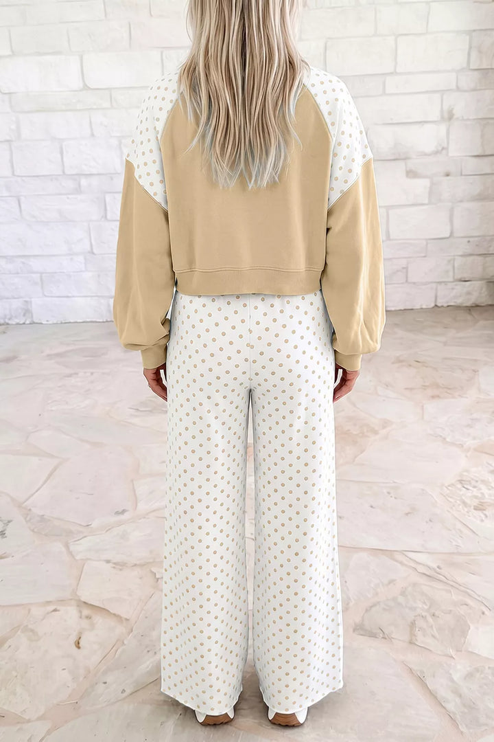 Back view of the tan cropped sweatshirt and polka dot wide leg pants