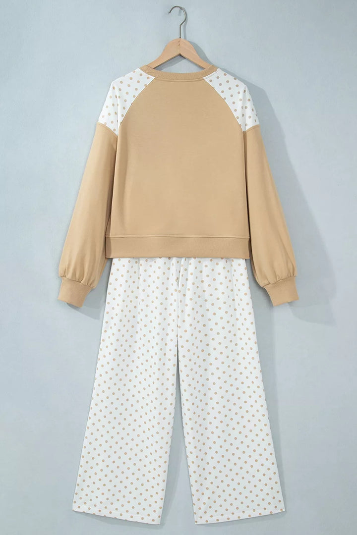 Tan cropped sweatshirt and wide leg pants set displayed on a hanger