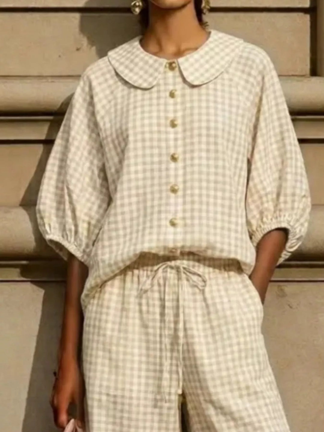 Close-up of beige gingham Peter Pan collar and buttons