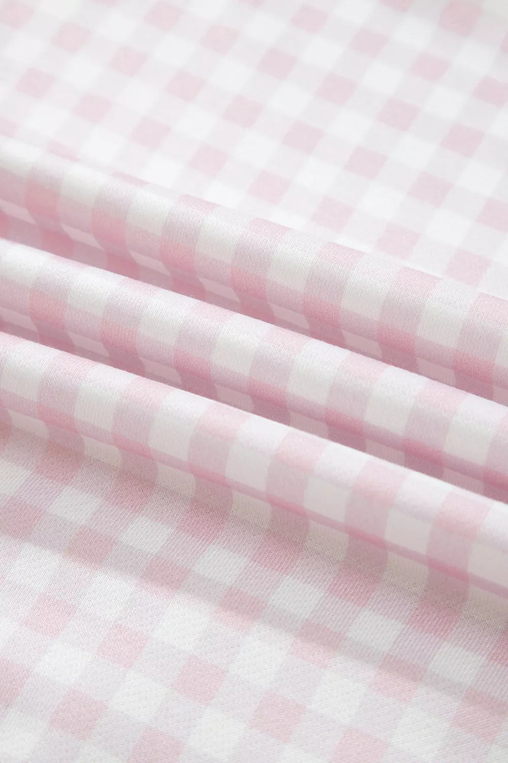 Folded gingham fabric texture in blush pink and white