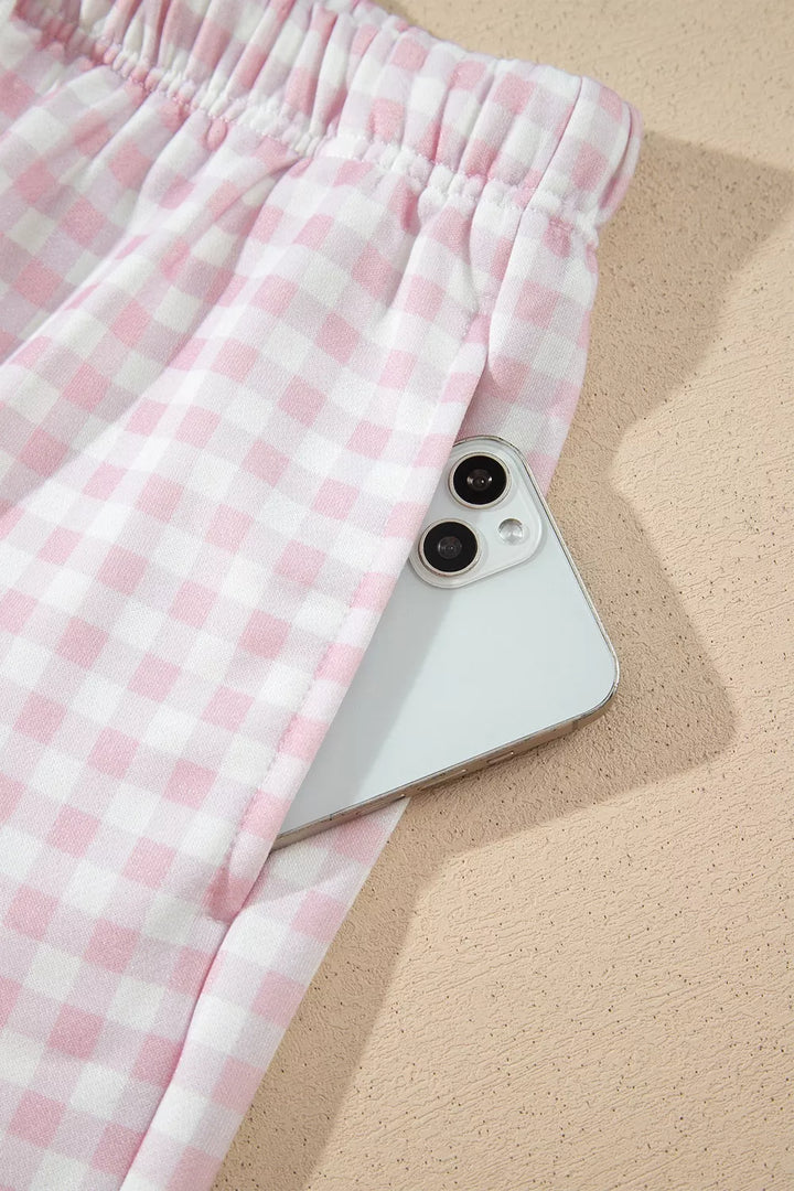 Gingham shorts pocket holding a phone, showing the pocket depth