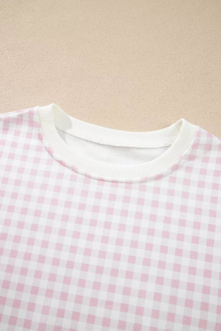 Close-up of the gingham sweatshirt round neckline with white ribbed trim