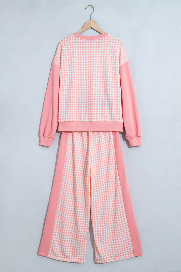Back of the coral pink gingham sweatshirt and wide leg pants on a hanger