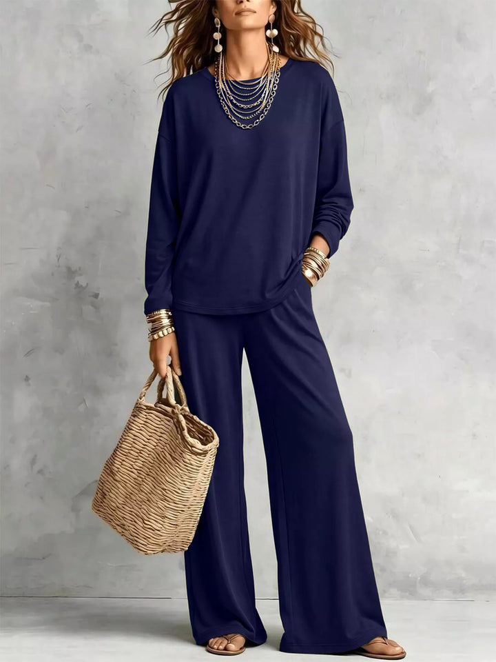 Navy long sleeve tee and wide leg pants set with a straw tote