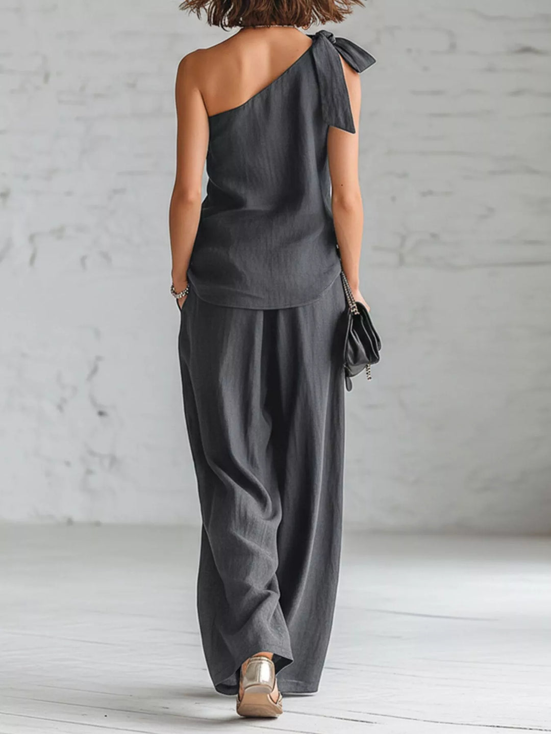 Back view of the charcoal one shoulder top and wide leg pants