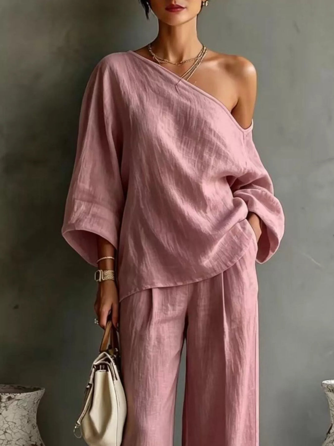 Close-up of the dusty pink one shoulder top with batwing sleeves