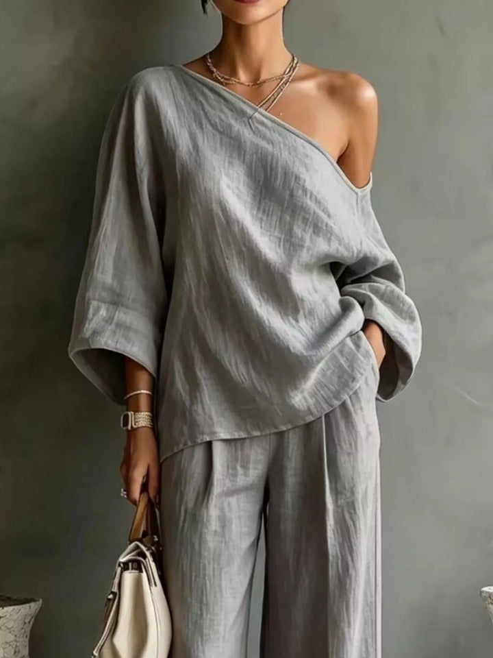 Close-up of the gray one shoulder top with batwing sleeves