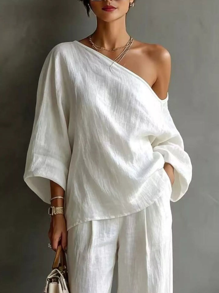 Close-up of the white one shoulder top with batwing sleeves