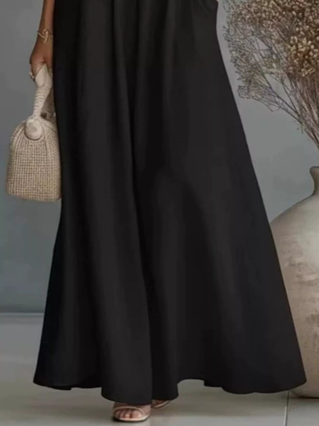 Lower half of the black wide leg maxi pants with wide flowing hem