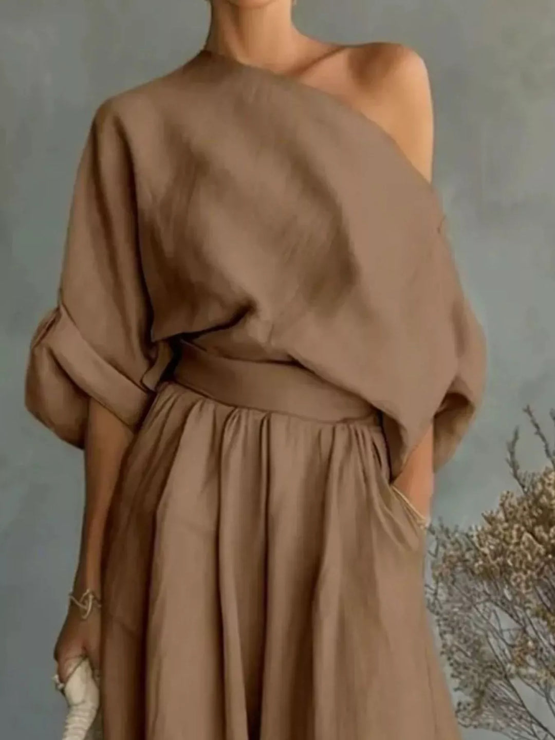 Closer view of the mocha one shoulder top with rolled sleeves