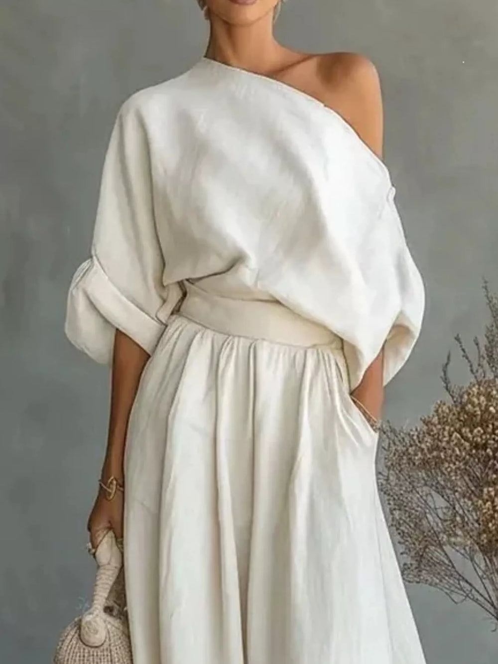 White one shoulder top with wide leg maxi pants, closer view of the waist
