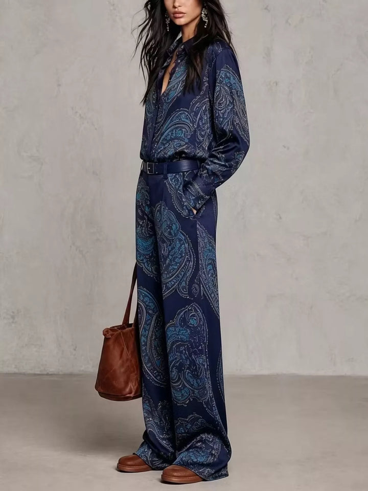 Navy paisley shirt and wide leg pants worn with a brown leather tote