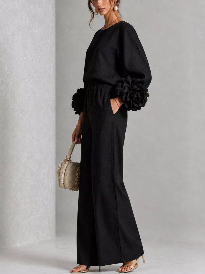 Side view of the black puff sleeve set with hand in the pocket