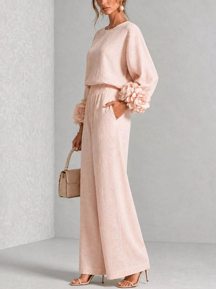 Side view of the blush pink matching set holding a small handbag