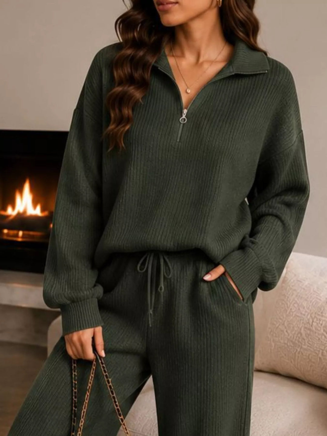 Close-up of the dark green half zip pullover and drawstring pants