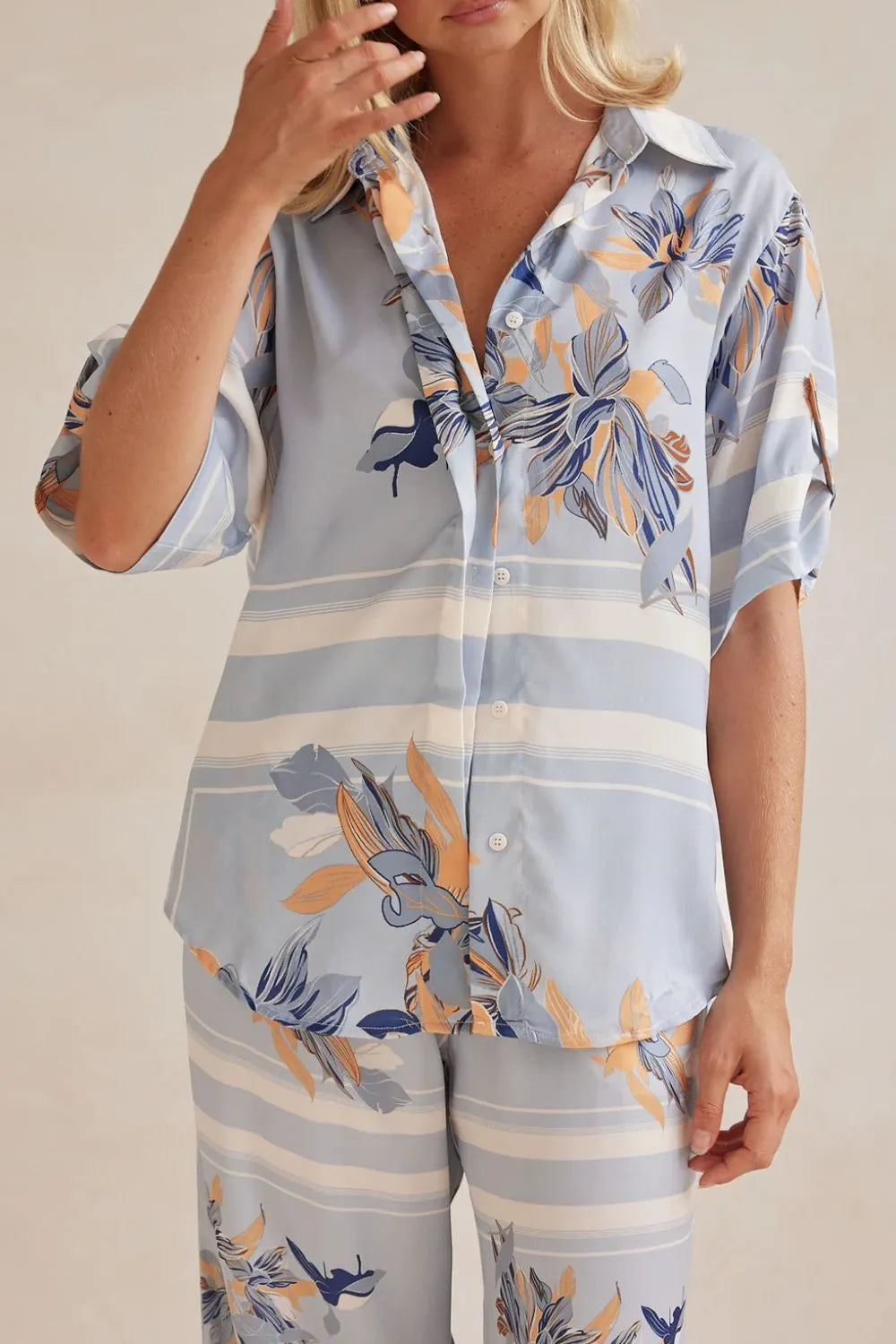 Close-up of the light blue floral satin look shirt worn over matching pants