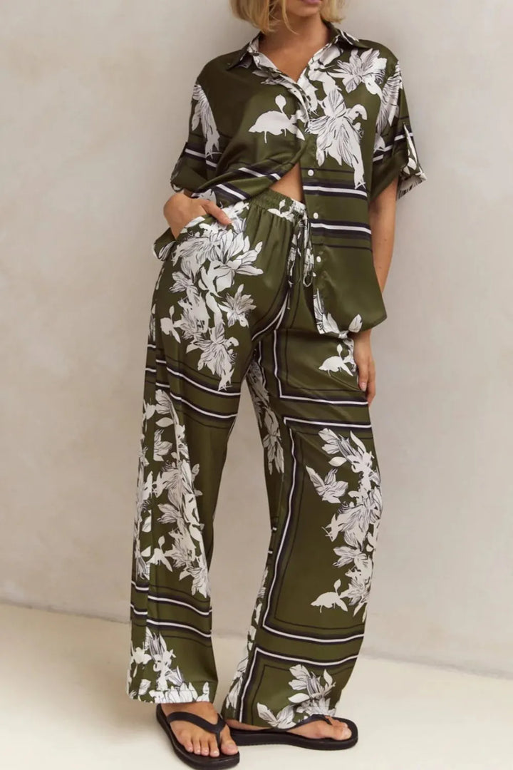 Olive floral two piece set standing with one hand in the pocket