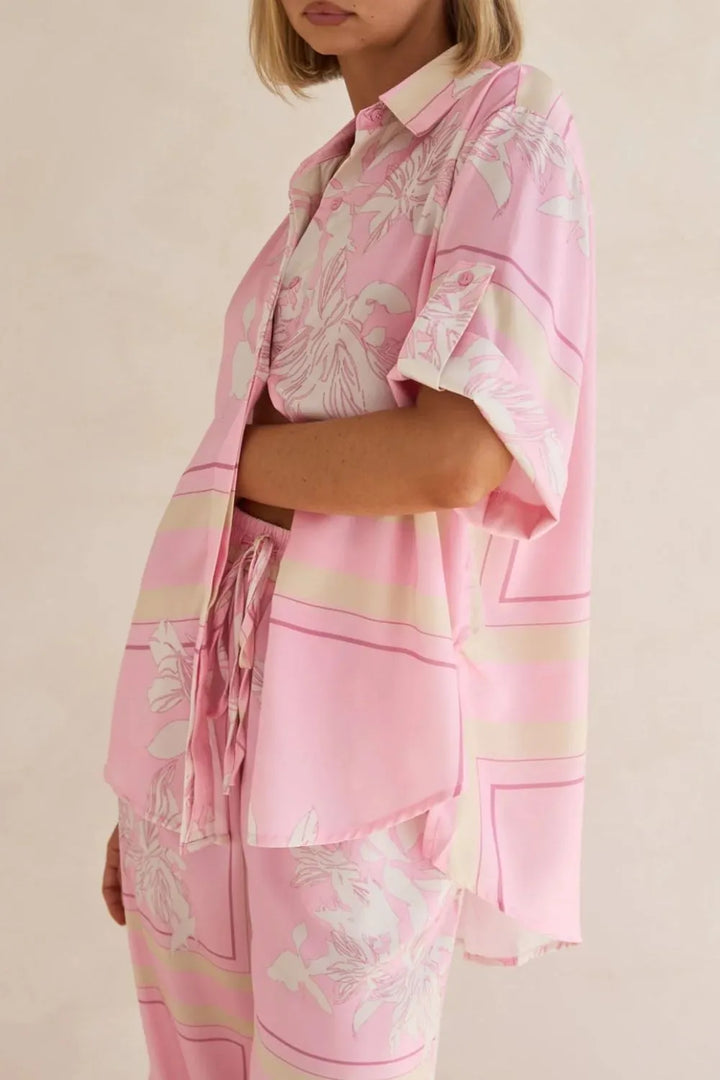 Side view of the pink floral shirt with the drawstring waist showing