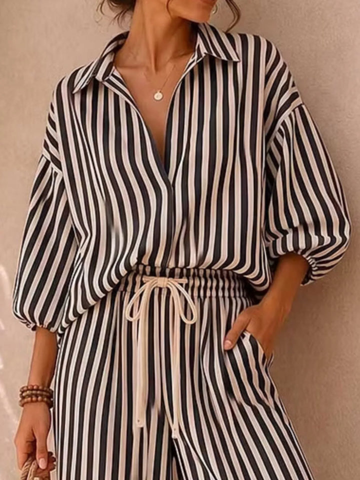 Close-up of the black striped shirt with drawstring waist of the pants