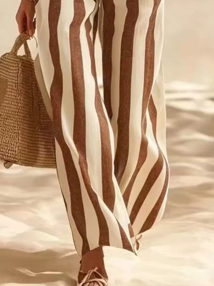 Detail of the brown striped wide leg pants beside a woven bag