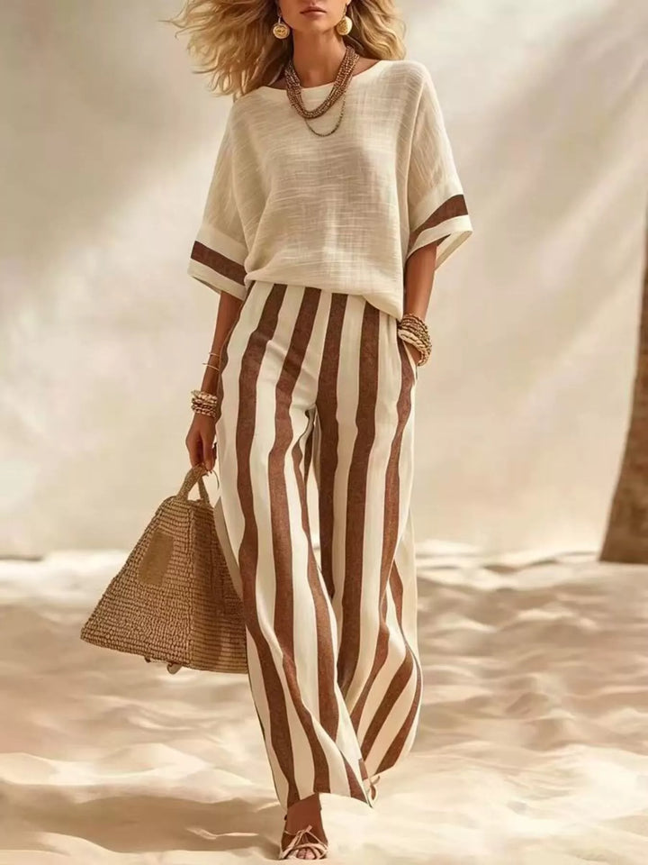 Brown striped matching set with a cream top, full outfit on sand