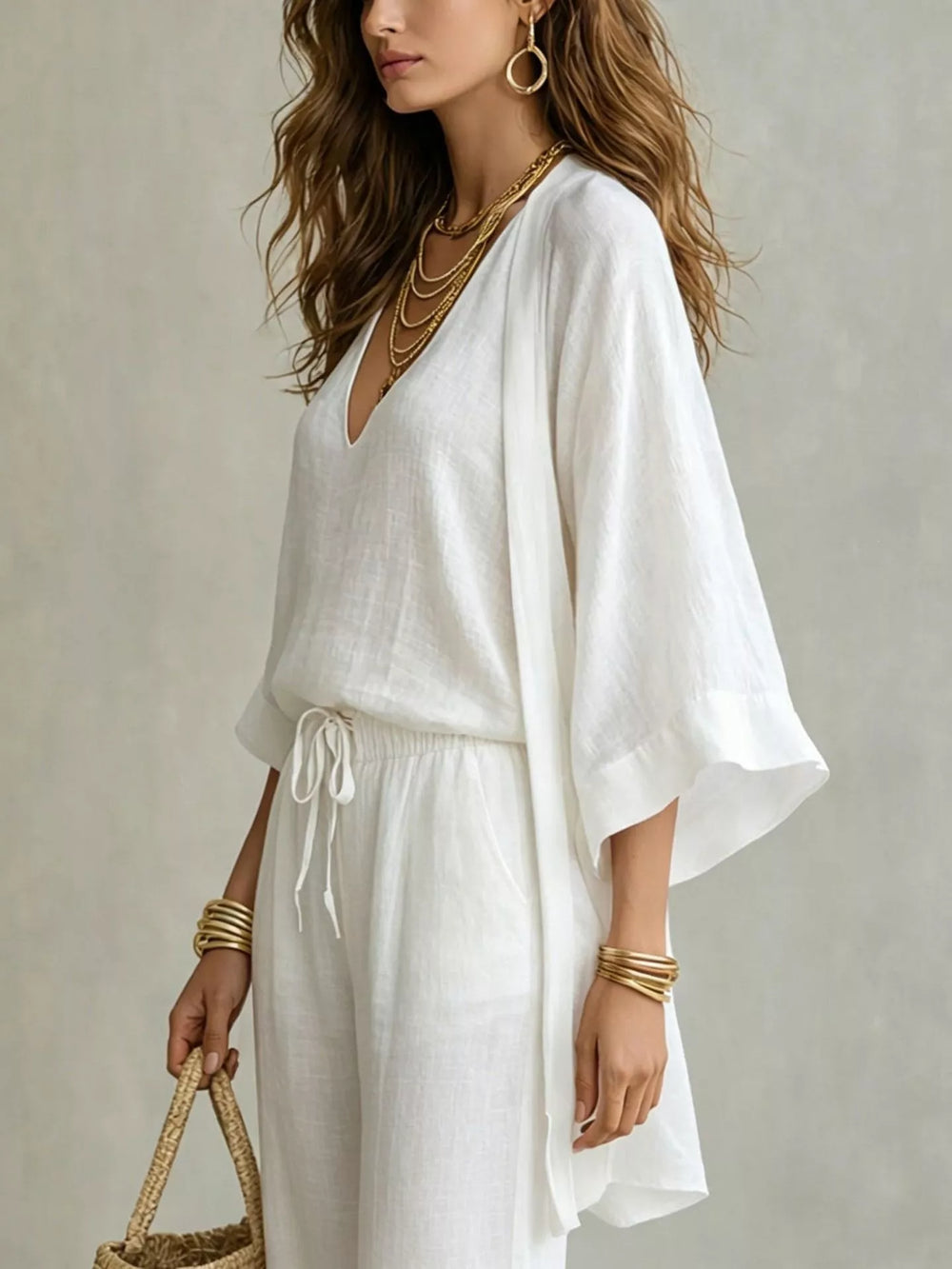 Three piece v neck top, cardigan and pants in white, close-up detail