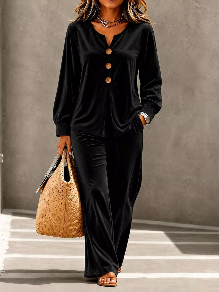 Black velvet-look top with wide leg pants, full outfit with a straw tote