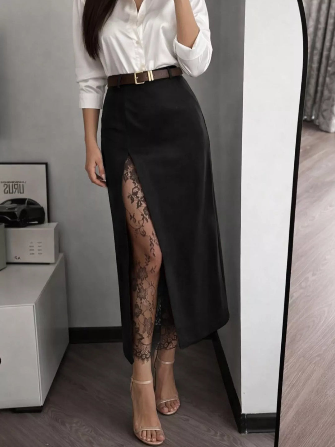 Black lace trim maxi skirt styled with a white satin blouse and heeled sandals