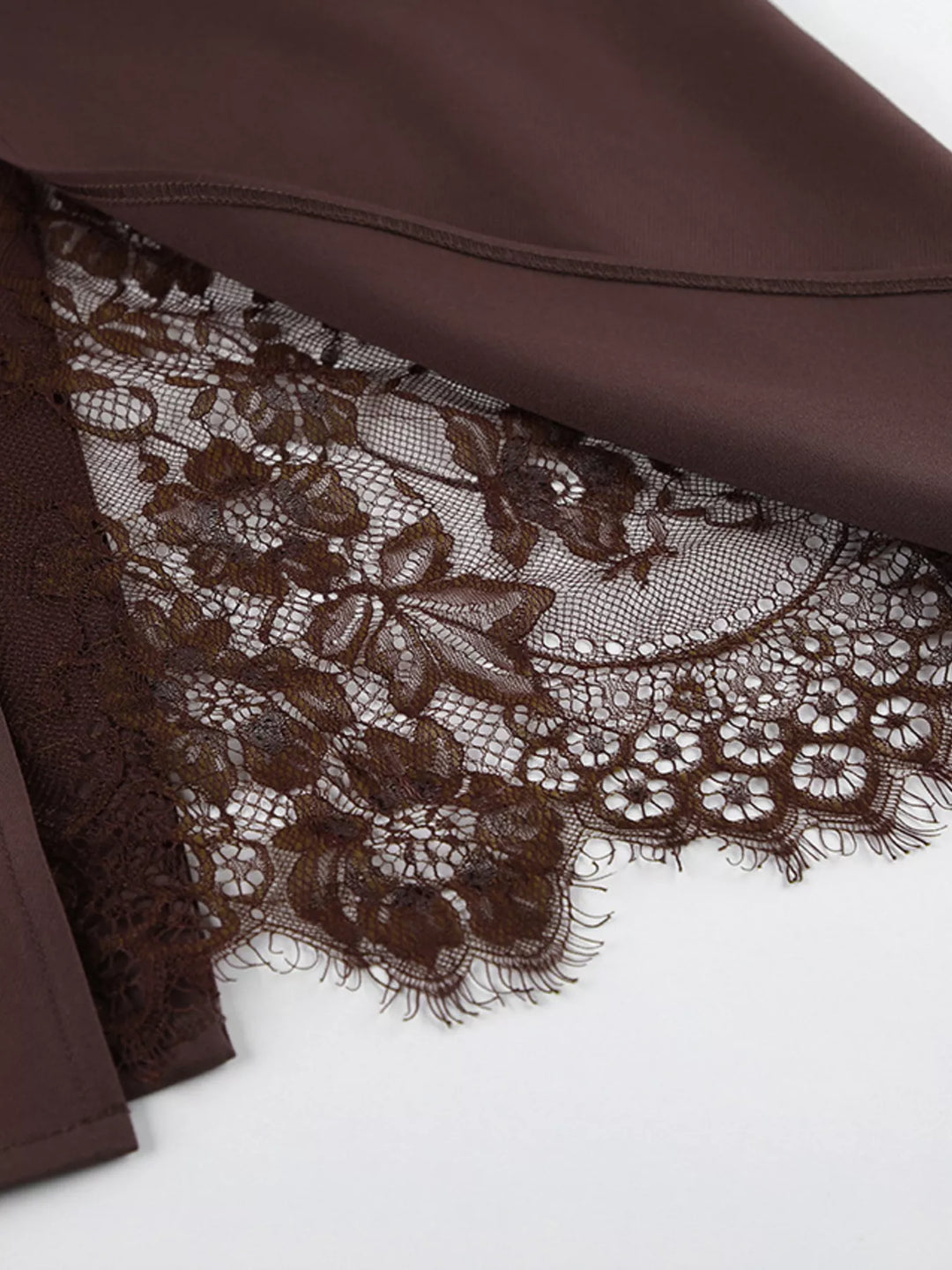 Floral lace trim peeking out from the slit of the chocolate brown skirt