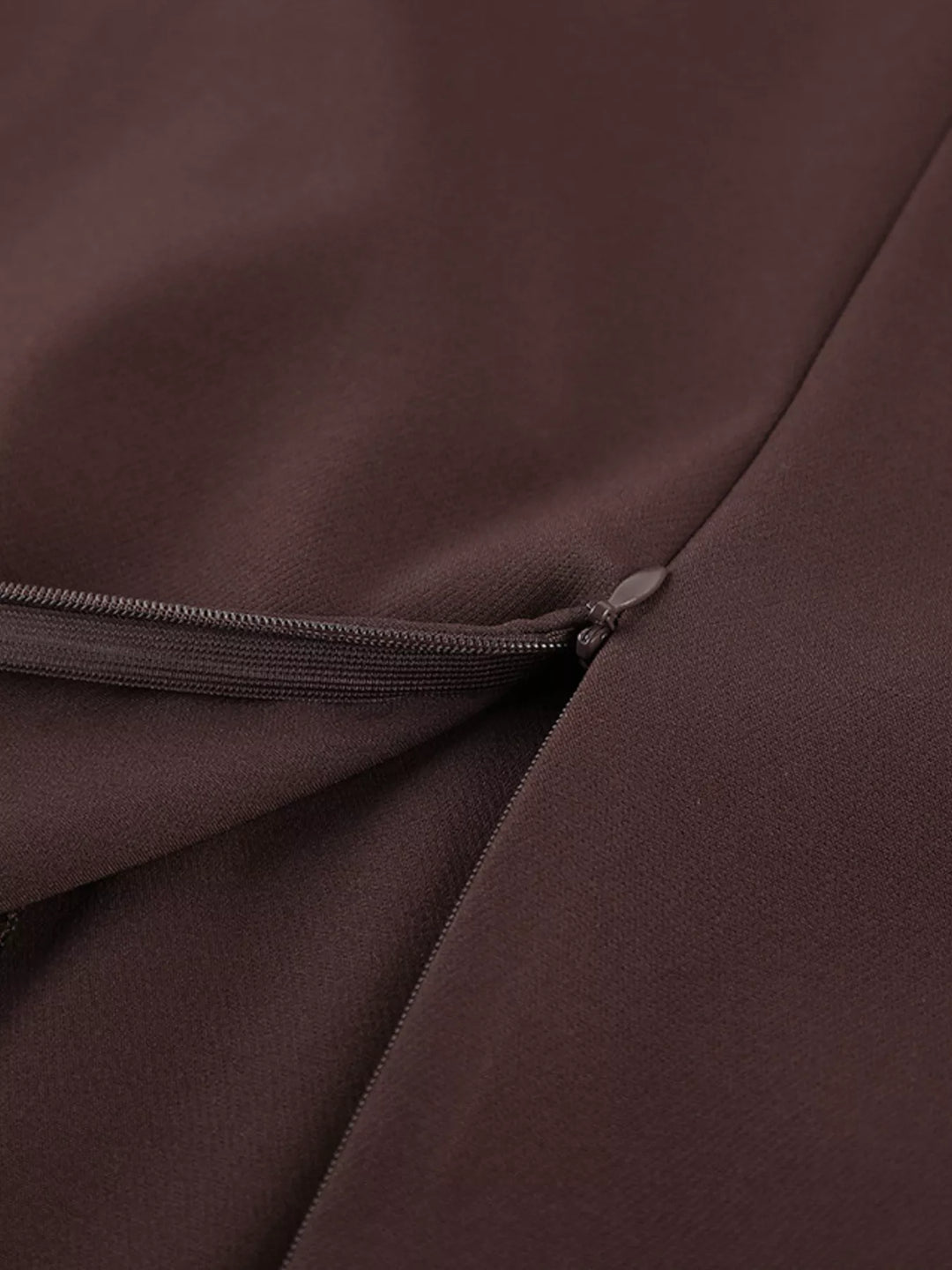 Brown maxi skirt waist detail with a belt loop and front fold