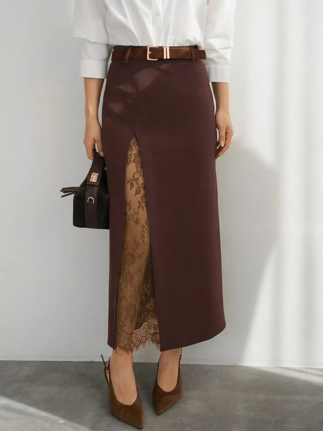 Chocolate brown maxi skirt styled with a white blouse, belt and pointed heels