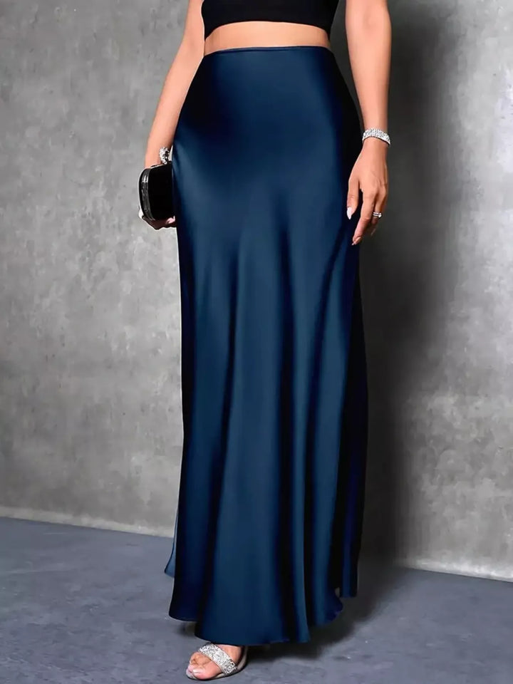 Side view of the peacock blue trumpet hem skirt with a black crop top