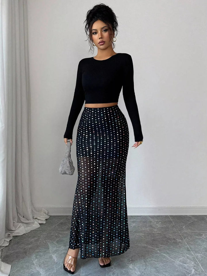 Front view of the black polka dot mermaid skirt with clear heels and silver bag