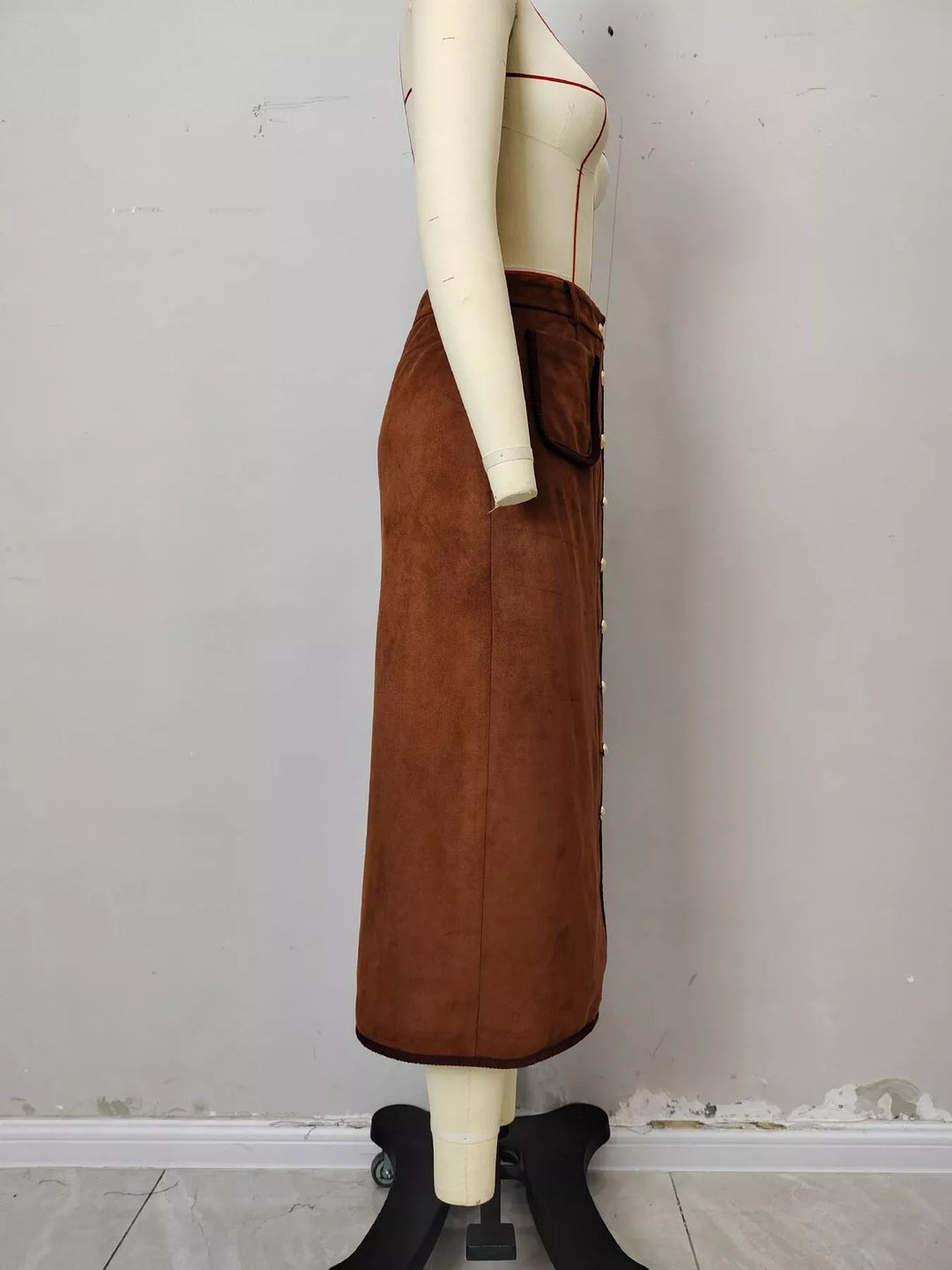 Side view of the rust A line midi skirt on a mannequin