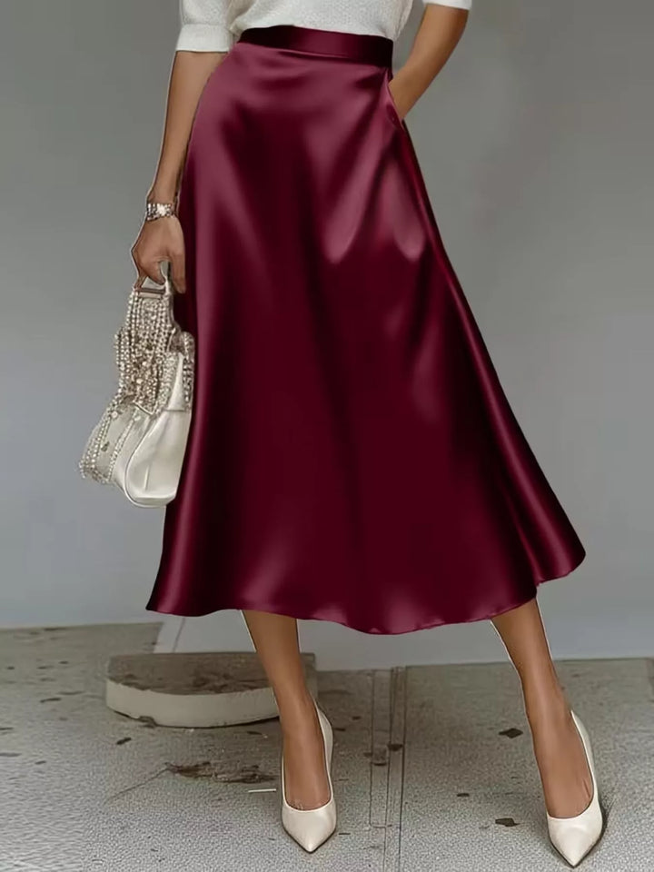 Women's midi skirt in burgundy, high waisted A line satin look, with white heels