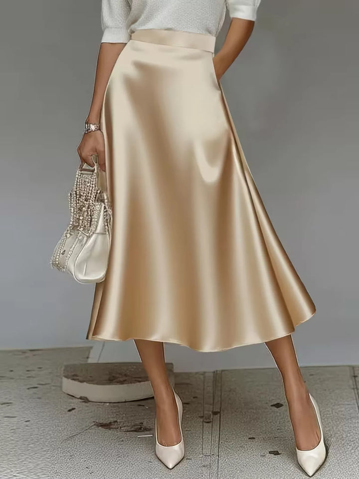 Champagne satin look A line midi skirt with a high waist and a woven bag