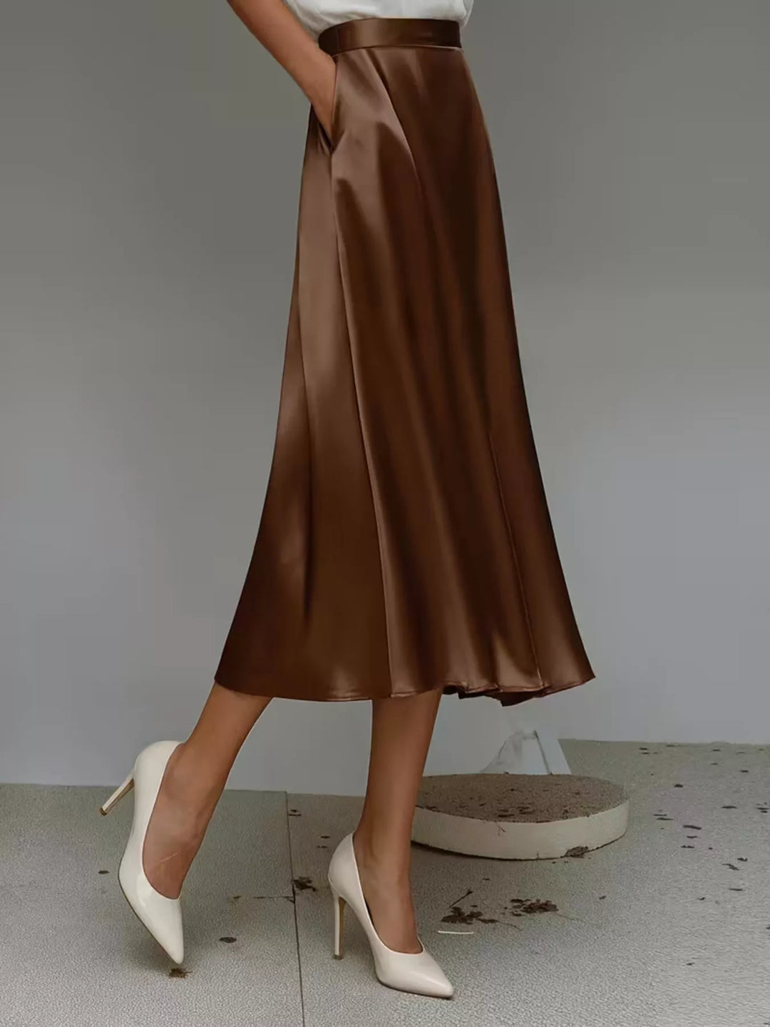 Side view of the chocolate brown A line midi skirt with white pumps
