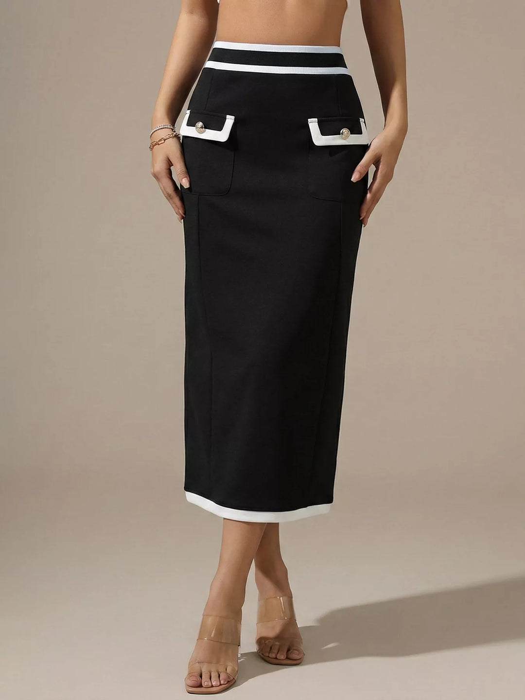 Women's midi skirt in black, high waisted pencil shape with white trim and front flap pockets