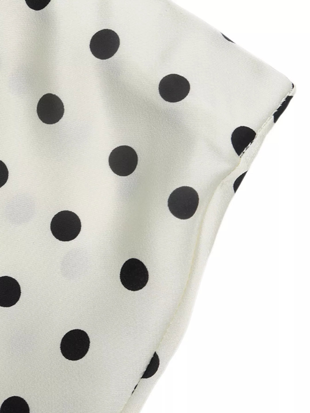 Cream skirt fabric draped to show the polka dot pattern and soft finish