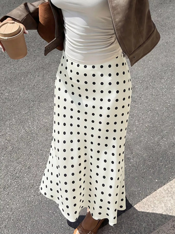 Cream polka dot skirt waist and flared hem, cropped torso view