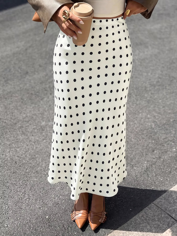 Women's midi skirt in cream with black polka dots, flared hem, front view