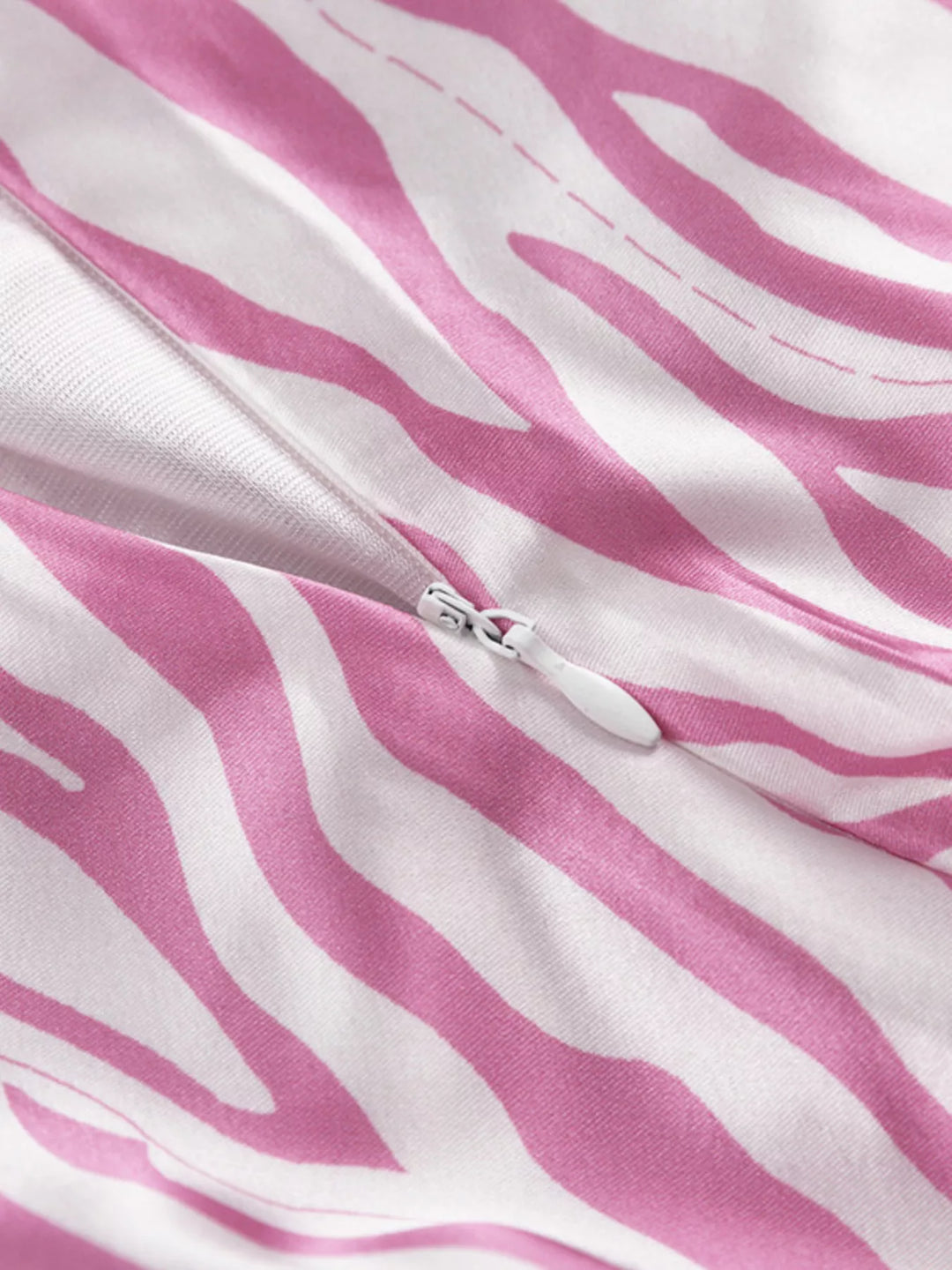 Close-up of the zebra print and hidden zipper on the light pink skirt