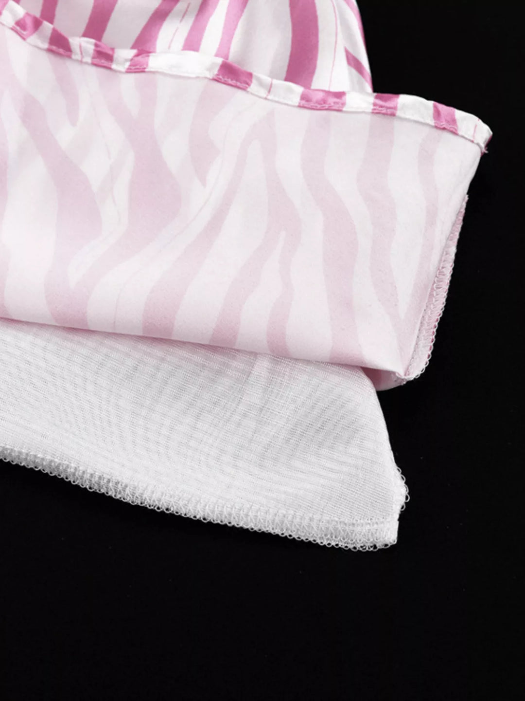 Detail of the light pink skirt hem and lining folded on black