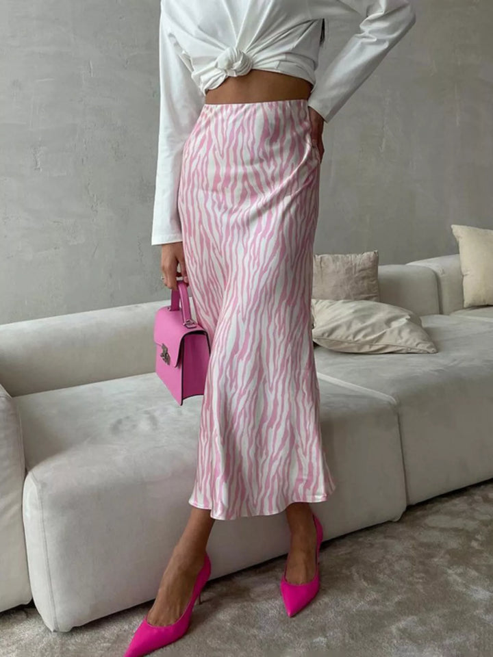Light pink zebra print midi skirt with a white knotted top and pink heels